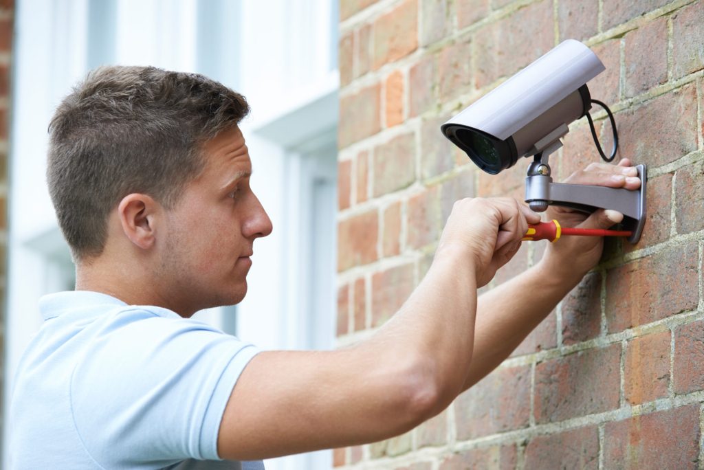 Certified technician installs security camera